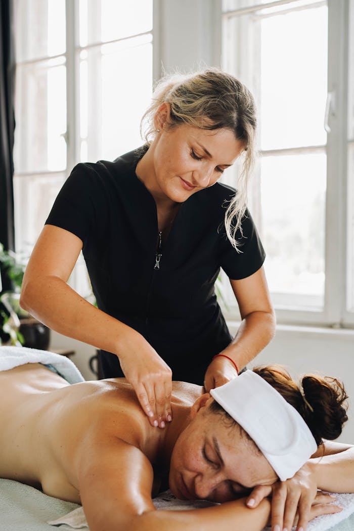 A relaxing back massage session in a serene spa setting, promoting comfort and relaxation.